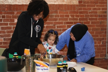 two EHS staff with child